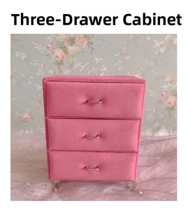 Front view of pink velvet 3-layer jewelry cabinet with silver handles and lace decor
