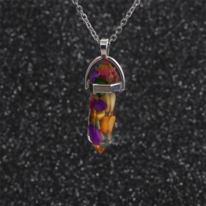 Close-up of hexagonal resin pendant necklace featuring colorful crushed stone inlay
