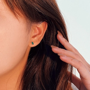 S925 sterling silver mini square earrings with green zircon worn on a female model