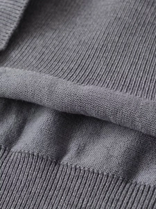 Close-up of grey knit fabric showing detail of flat and ribbed stitch textures