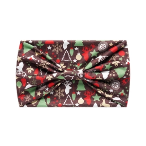 Close-up of brown festive headband featuring reindeer and Christmas tree patterns