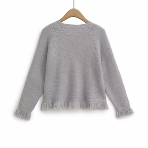 Light gray knit cardigan with fringe trim on sleeves and hem against a white background