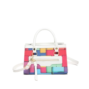 Colorful geometric tetris pattern handbag with white handles and long tassel detail