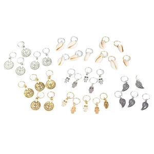Gold and silver hair rings with leaf, shell, and hamsa charms on white background