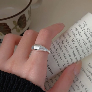Close-up of 925 sterling silver croissant ring with polished spiral texture on a finger