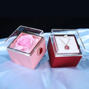Rotating rose flower jewelry box with pink gemstone necklace in elegant gift display