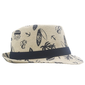 Detail of light beige woven fedora straw hat with tropical surf theme prints and blue band