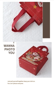 Close-up of stitching on a red non-woven Christmas gift bag with Santa Claus print