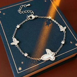 Detailed macro of a silver butterfly bracelet with zircon and shell inlay on jewelry box