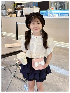 Pink girls crossbody bag featuring large white bow and elegant pearl handle detail