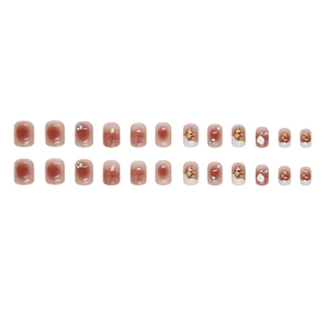 Short blush French press-on nails with red-brown gradient, gold foil and rhinestones