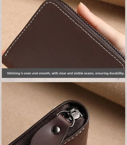 Close-up of precise white stitching and metallic zipper on high-quality brown leather card wallet