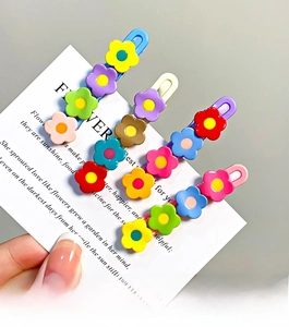 Close-up of colorful floral hair clips with resin flower charms on display cards