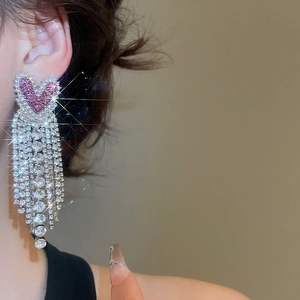 Sparkling pink heart tassel earrings with silver rhinestones on female model