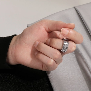 Detailed view of silver punk wide band ring with non-slip industrial texture on finger
