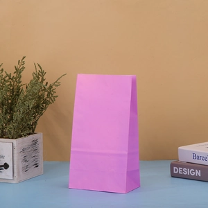 Close-up of pink kraft paper gift bag with rectangular vertical structure for parties