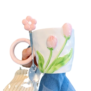 Ceramic tulip mug with pink embossed flowers and matching floral spoon handle detail