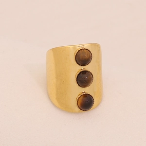 Close-up of vintage gold stainless steel wide ring with three round tiger eye stones