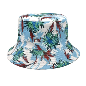 Detail of white reversible bucket hat featuring tropical floral patterns for outdoor wear