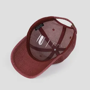 Macro shot of 100% cotton washed burgundy baseball cap interior with quality care labels