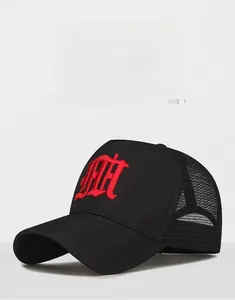Detail of breathable black mesh trucker hat with 3D red embroidery and curved visor