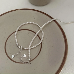 S925 sterling silver minimalist pearl bracelet featuring two heart charms and lobster clasp