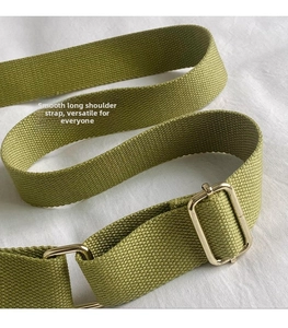 Detail of adjustable avocado green canvas shoulder strap with polished gold buckle