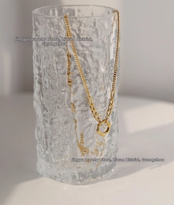 Close-up of minimalist 18K gold-plated titanium steel necklace with circular ring pendant