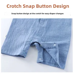 Detail of infant romper crotch with plastic snaps and breathable cotton gauze texture