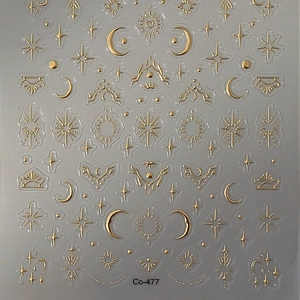 3D gold star and moon nail stickers with metallic celestial patterns and sun designs