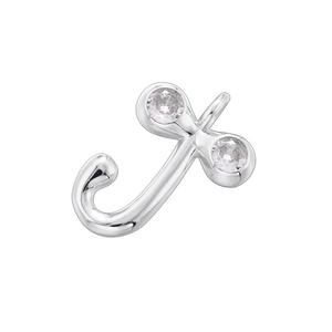 Detailed macro view of silver letter J pendant with inlaid cubic zirconia stones