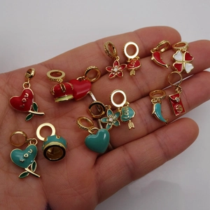 Gold-plated enamel charms featuring heart, crown, and clover designs for DIY bracelets
