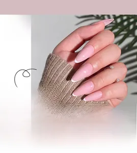 Macro detail of long almond-shaped press-on nails with pink base and white French tips