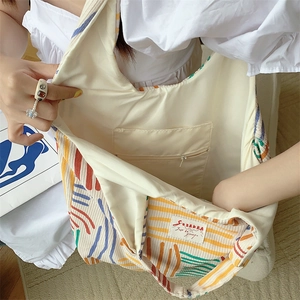 Detail view of large striped canvas tote bag interior with a hidden zipper pocket inside