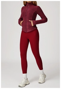 Detail view of burgundy fleece jacket and red leggings for outdoor autumn fitness