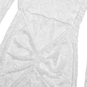 Close-up of intricate lace texture and stitching details on a white bodycon dress