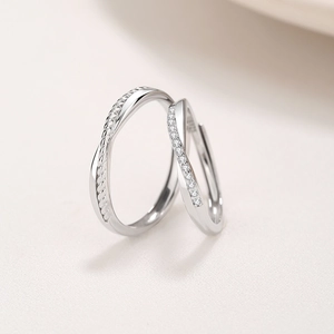 Elegant Mobius S925 silver couple rings featuring a twisted design with pavé diamonds