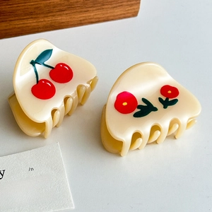 Set of two cream acetate hair claws with cute cherry and floral patterns for women