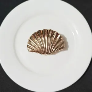 Elegant large gold shell hair claw clip made of textured alloy for a sleek back hairstyle
