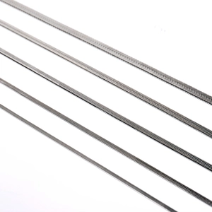 Detail view of five different widths of stainless steel snake chains on white background