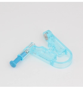 Close-up of a disposable blue ear piercing gun showing plastic body and sterile needle