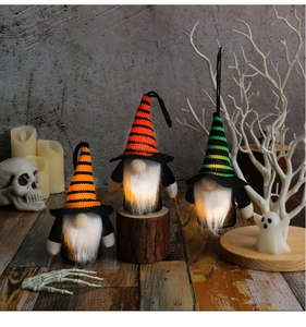 Three glowing Halloween faceless gnomes with striped hats and white lighted beards