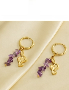 Detailed shot of titanium steel musical note earrings with purple natural crystal stones