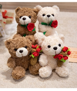 Close-up of plush teddy bears in brown and beige with red roses for gift scenes
