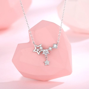 925 silver star pendant necklace with cubic zirconia on a soft pink background
