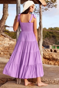Detail of purple backless tiered maxi dress showing smocked bodice and layered ruffle skirt
