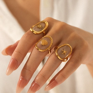 Vintage gold stainless steel rings with sea shell, starfish and sun motifs on fingers