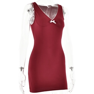 Close-up of sleeveless V-neck dress with white bow detail and contrast piping in wine red