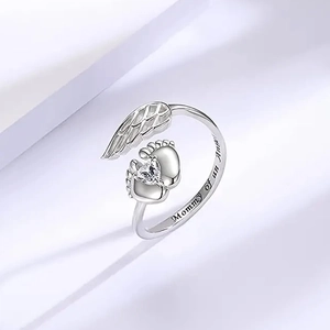 Mommy of an Angel ring with angel wings and baby footprints in polished silver