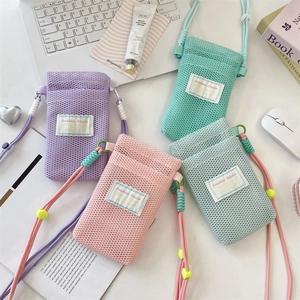 Detailed view of pastel mesh crossbody phone bags with Sorakka Studio label and rope strap